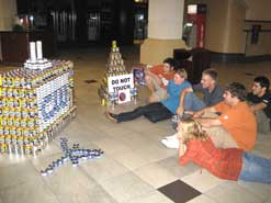 kids looking at project made from cans