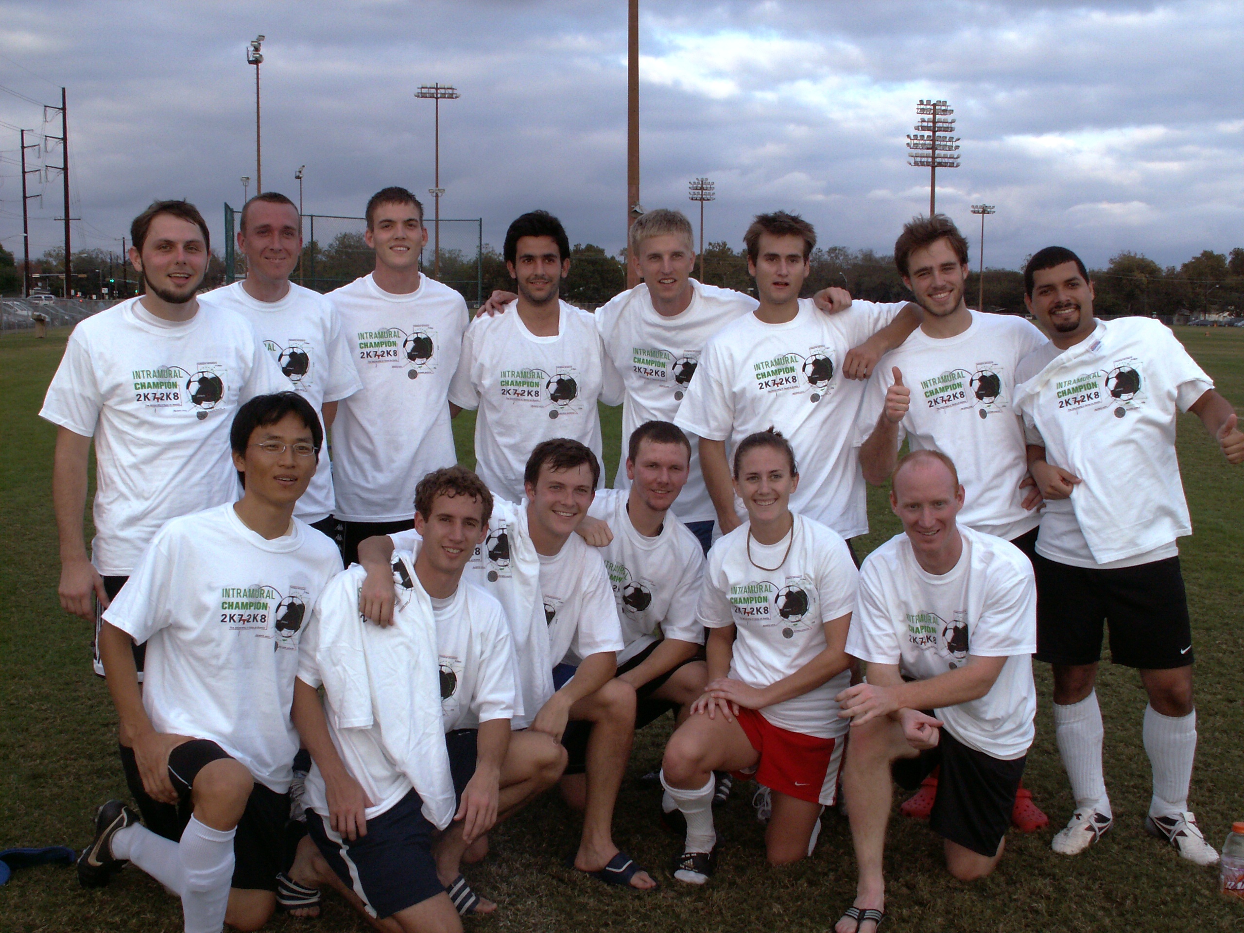 soccer team posing for photo and smiling