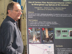 man standing next to presentation board