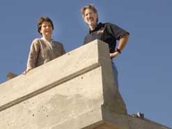 two people standing on edge of bridge